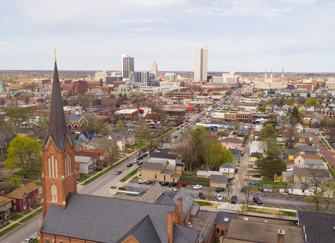 Greenwood, IN - Aerial View of a Church and Main Street Commercial Buildings in Downtown Greenwood Indiana on a Sunny Day